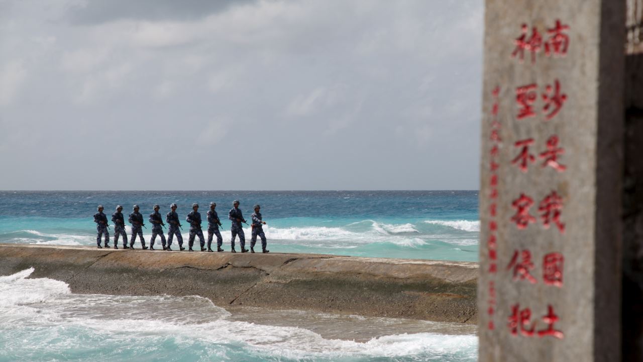 Chinese soldiers march in a line on the Spratly Islands in the contested South China Sea.