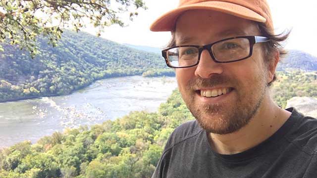 Portrait of Brian Williamson hiking on the Appalachian Trail on the bluffs over Harpers Ferry.