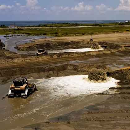 Aerial photograph of heavy machinery working on a dredging project.